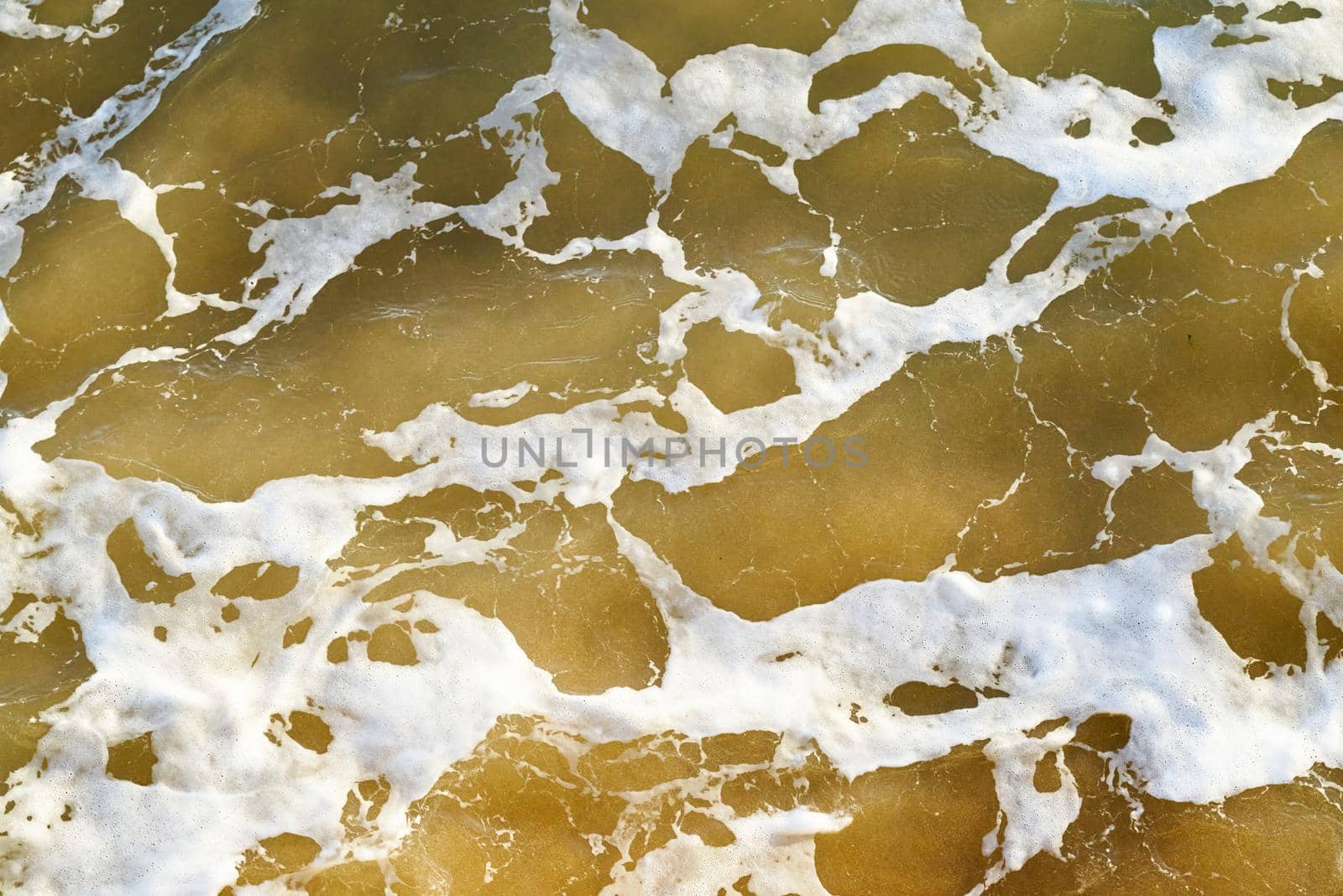 Brown sea water abstract with white bubbles by ChrisWestPhoto
