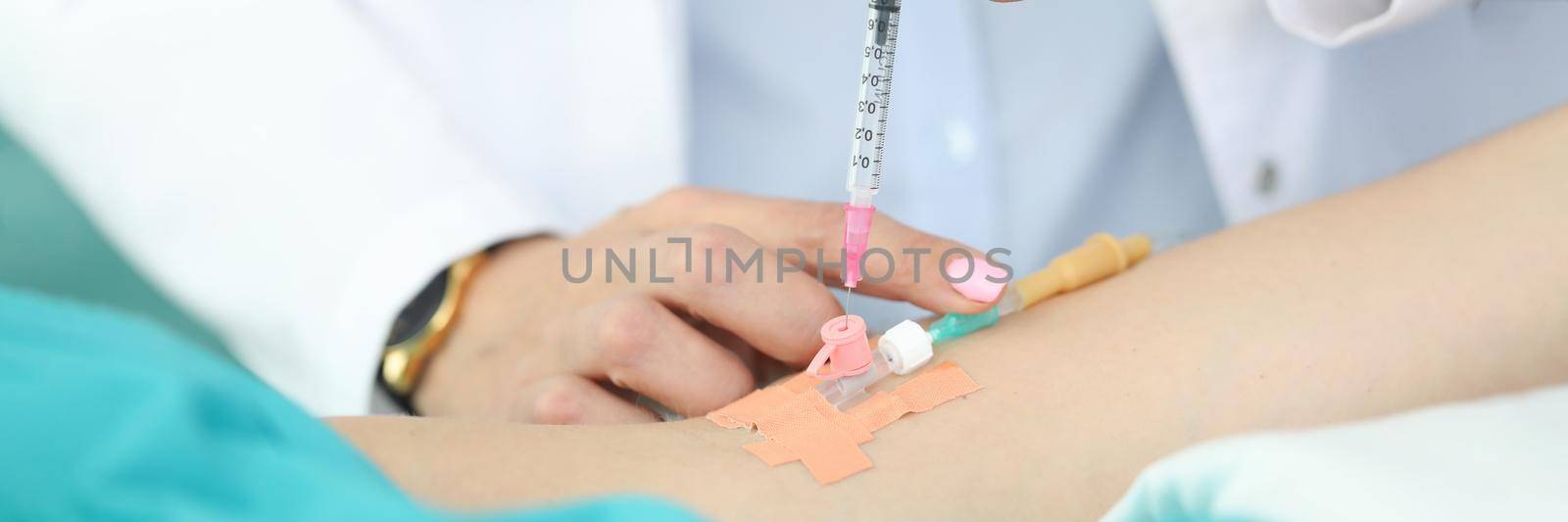 Doctors hands place dropper in patients hand. Withdrawal from body substances that change consciousness. Sterility drugs for injection into vein. Drug entry through vein. Infusion medication
