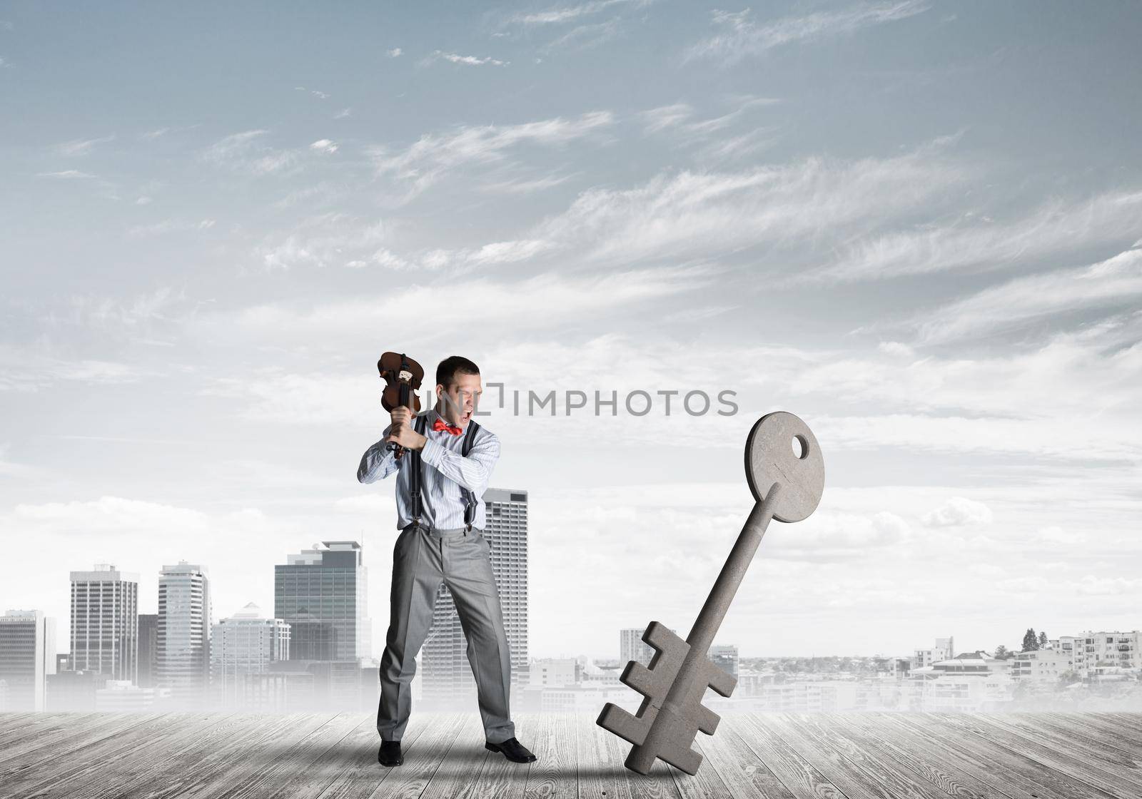 Determined businessman against modern cityscape breaking with violin stone key figure