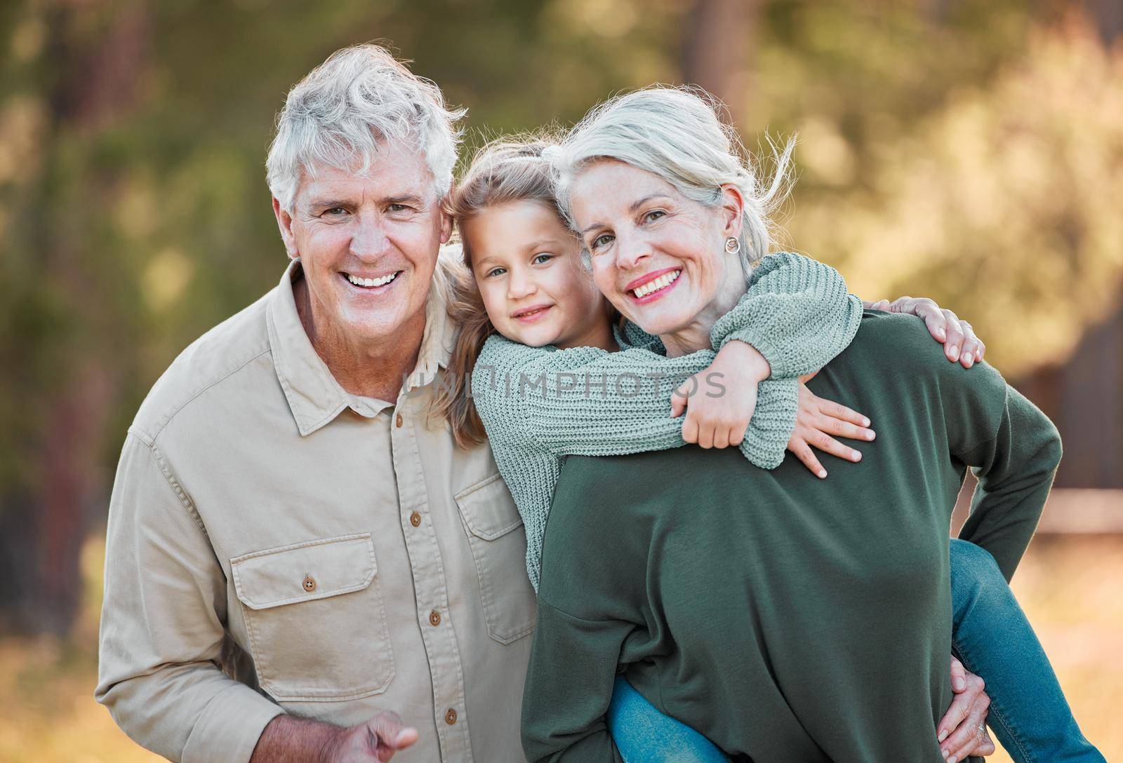Shot of a senior couple spending time outdoors with their granddaughter.