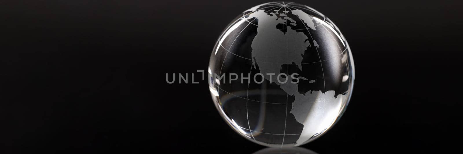 Closeup of glass globe on black background by kuprevich