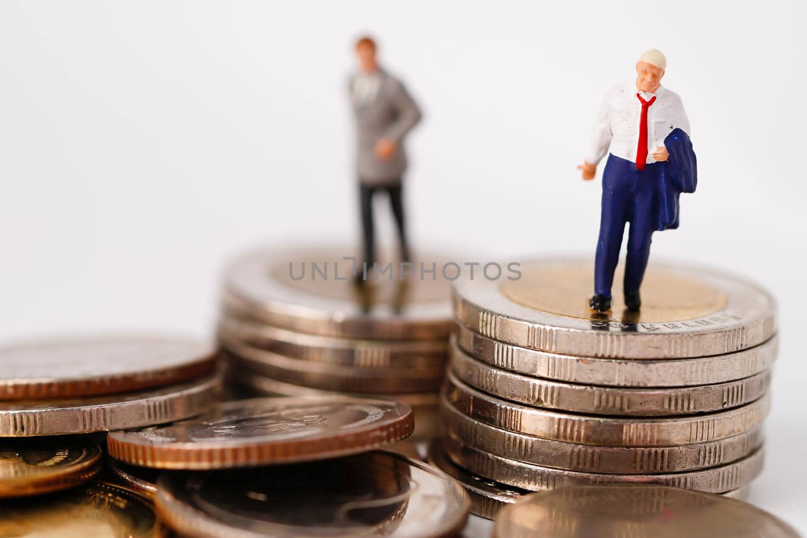 Business man miniature people stand on coin and calculator, management business finance concept.