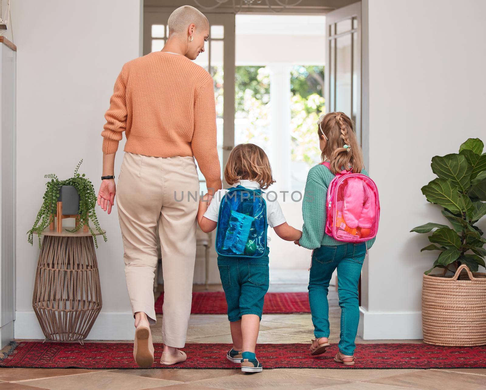 Were ready for the day. Shot of a woman leaving home with her two children. by YuriArcurs