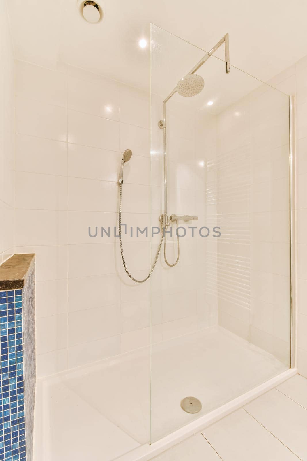 The interior of a spacious modern bathroom in a cozy residential apartment with a glazed shower cabin