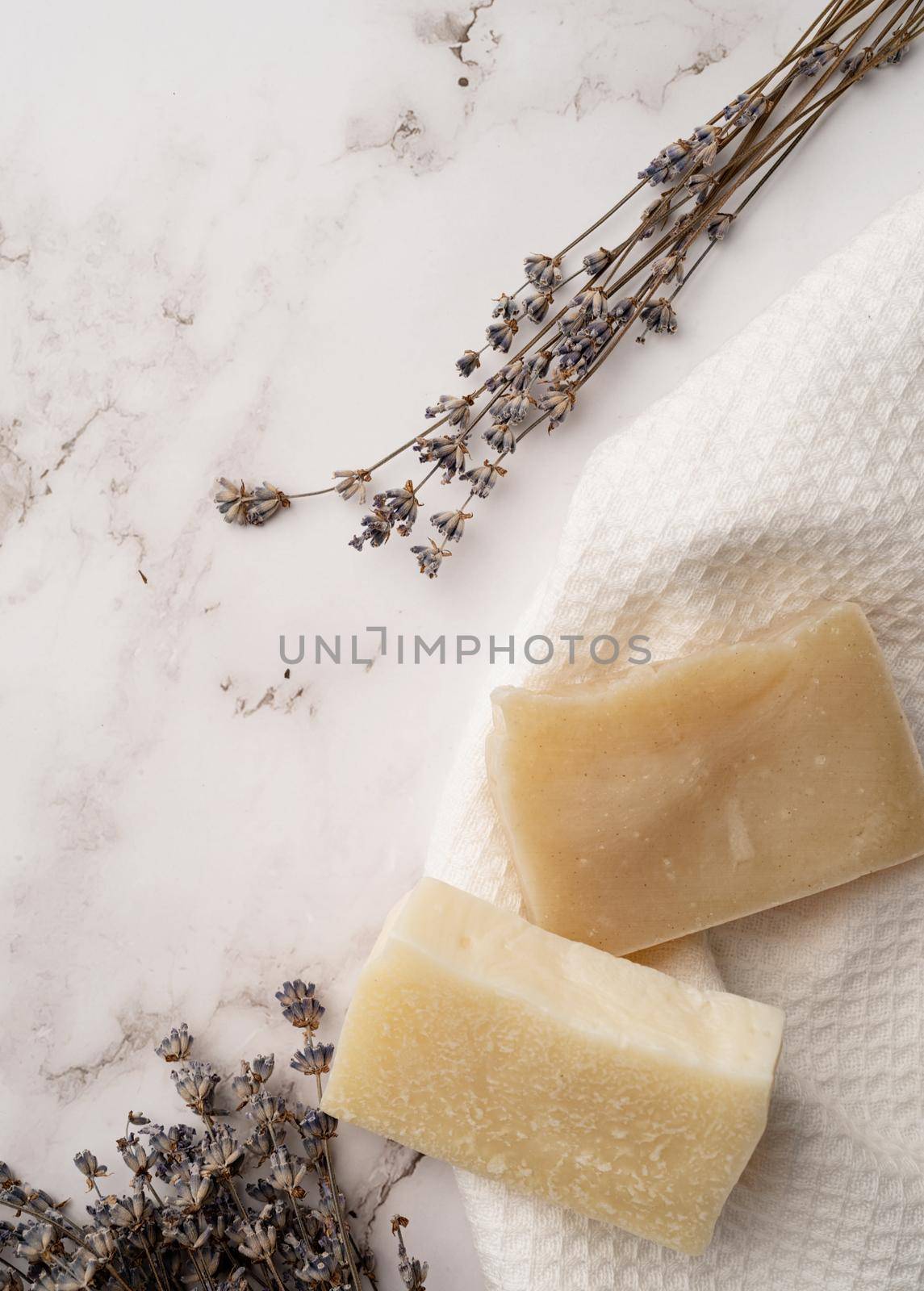 Natural cosmetics. Handmade soap bars on marble background with lavender top view. mockup design