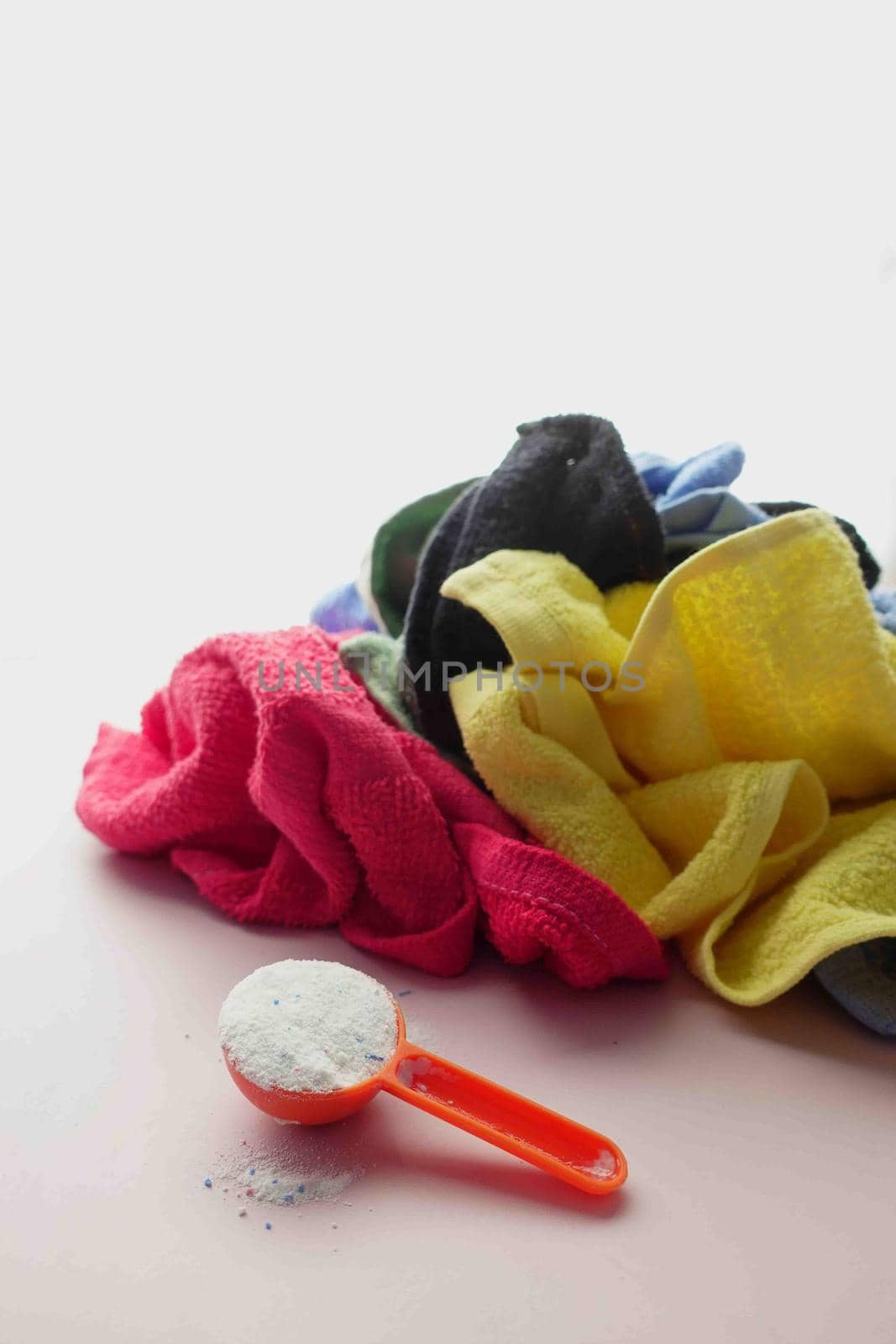 Washing powder in plastic spoon on blue background by towfiq007