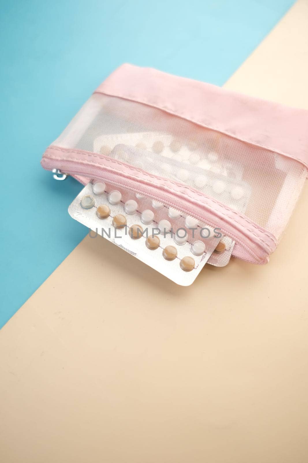 birth control pills on wooden background, close up .