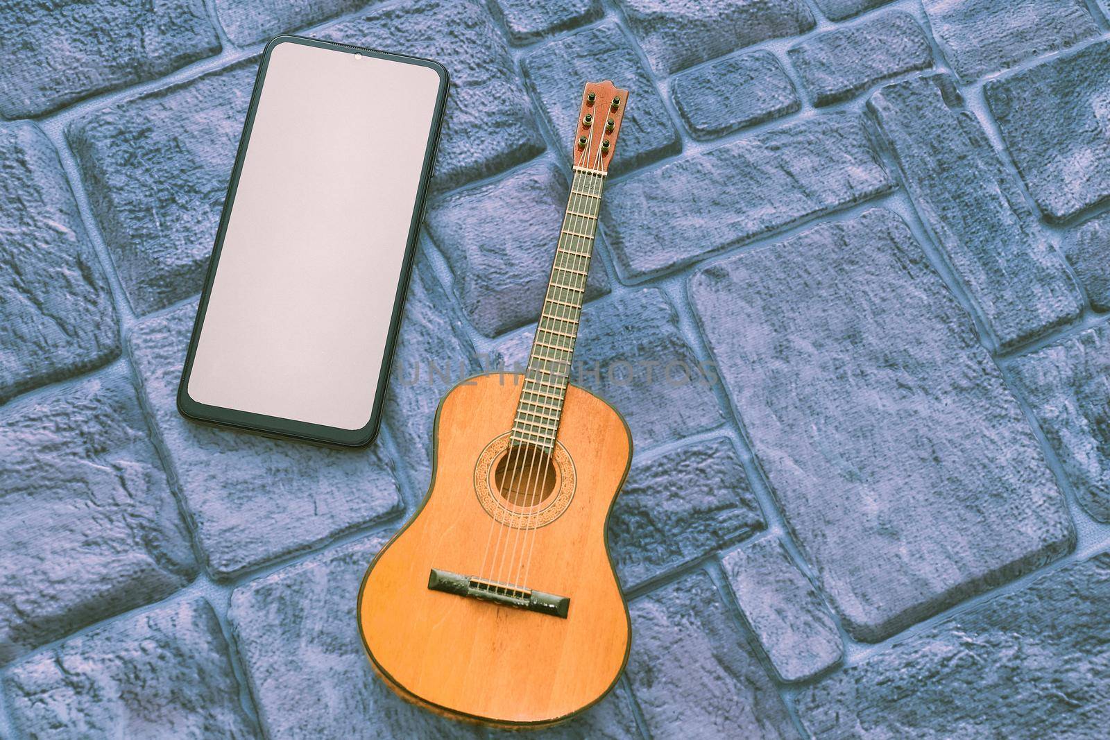 a brief record of facts, topics, or thoughts, written down as an aid to memory. a stringed musical instrument, with a fretted fingerboard, typically incurved sides, and six or twelve strings