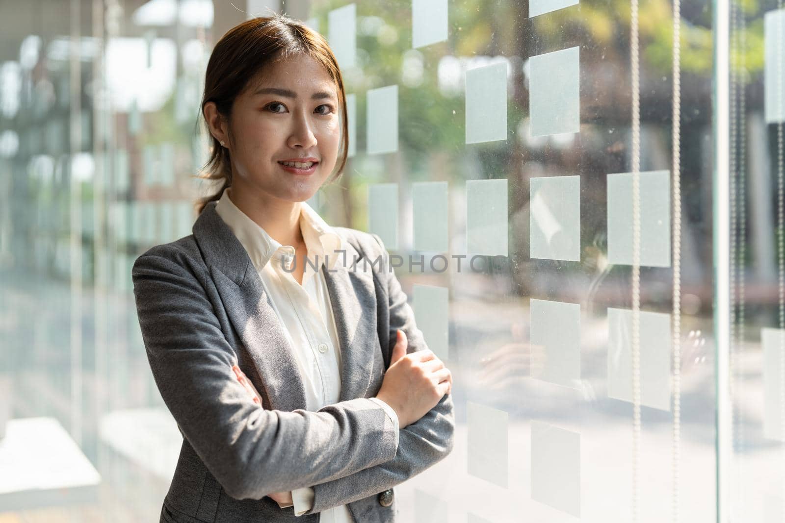 Pretty young business asian woman, successful confidence with arms crossed in financial building