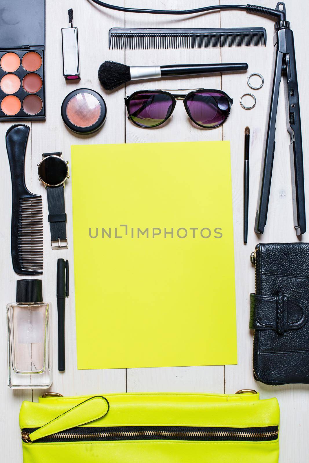 Cosmetics and women's accessories fell out of the green handbag on white background. by nazarovsergey