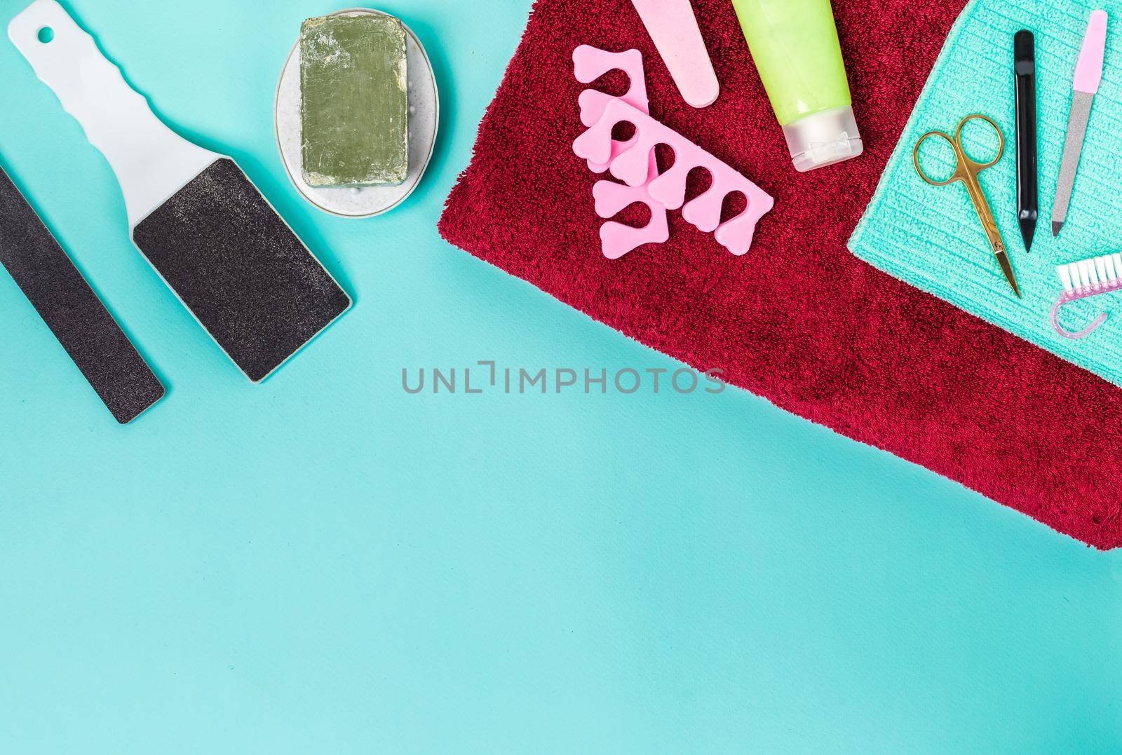 Top view of manicure and pedicure equipment on blue background. Still life. Copy space