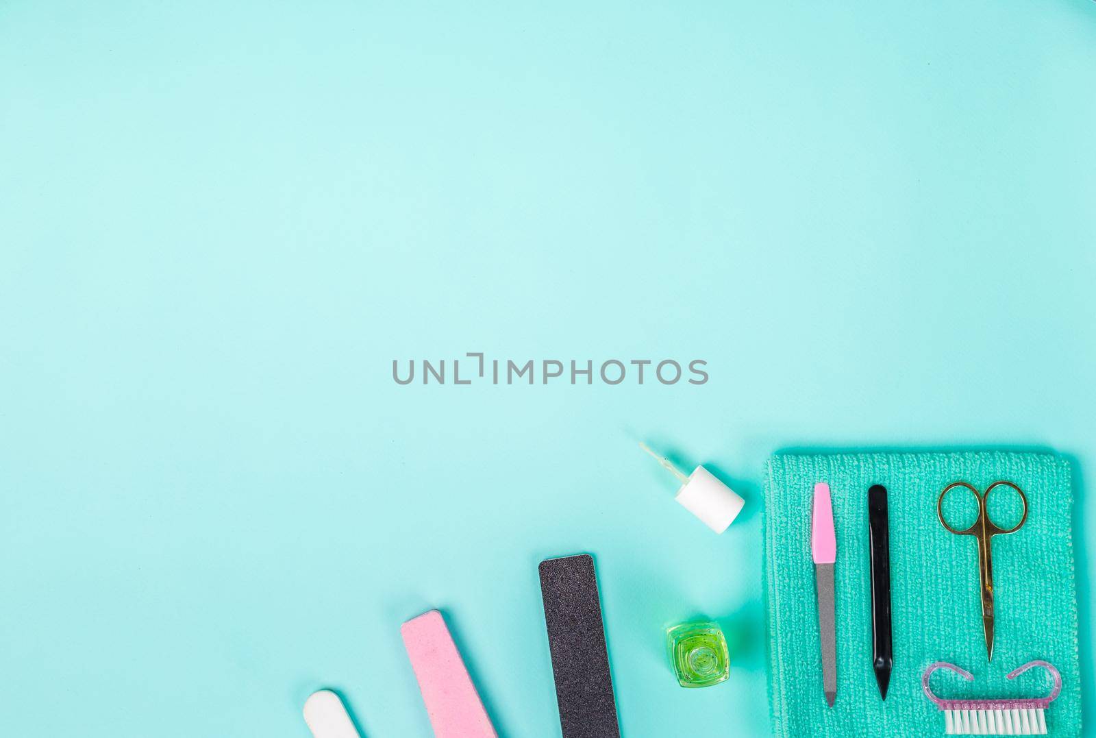 Top view of manicure and pedicure equipment on blue background. Still life. Copy space