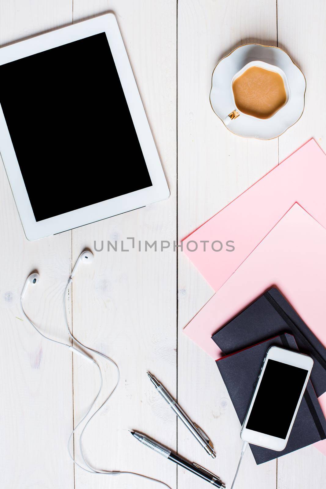 Flat lay, top view, mock up women's accessories on a white background. phone, pen, paper, a cup of coffee, notebook