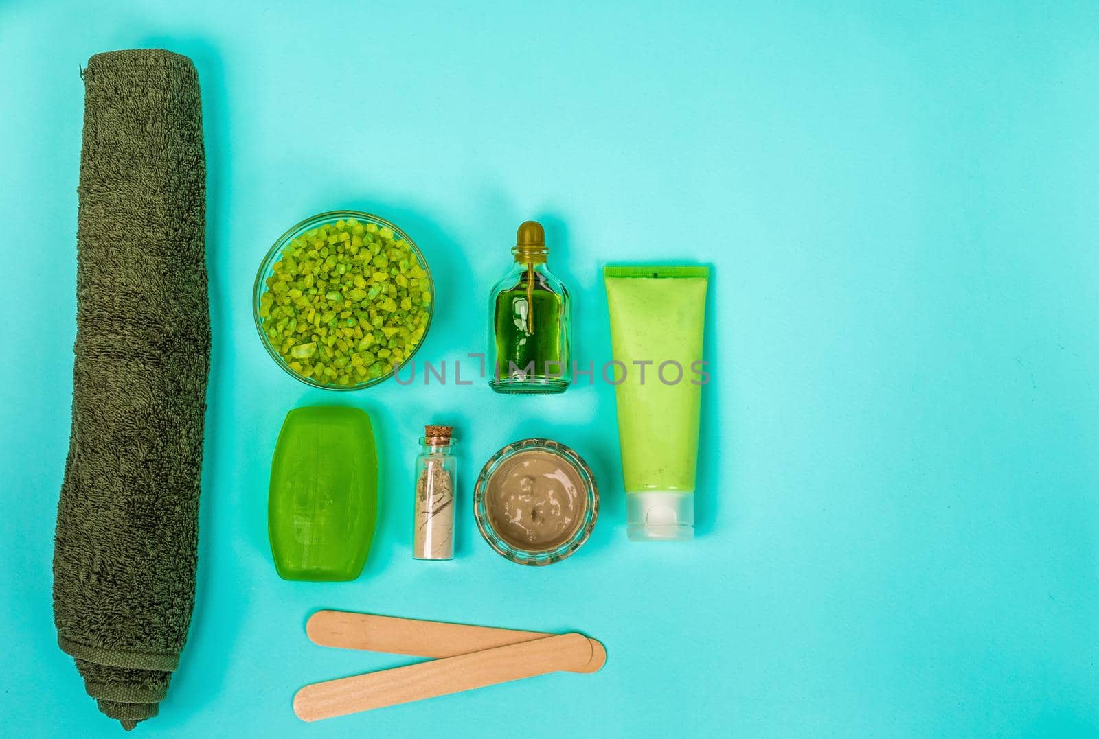 Spa set: soap, mask, oil, sea salt and towel. Top view. Still life Copy space