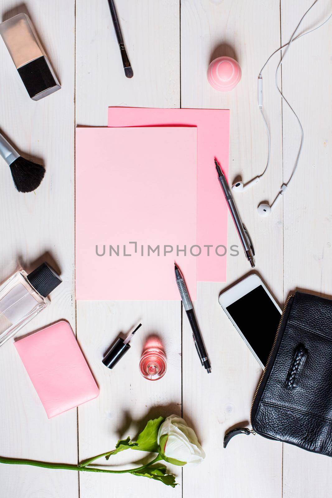 Flat lay, top view, mock up women's accessories on a white background. phone, pen, paper cosmetics