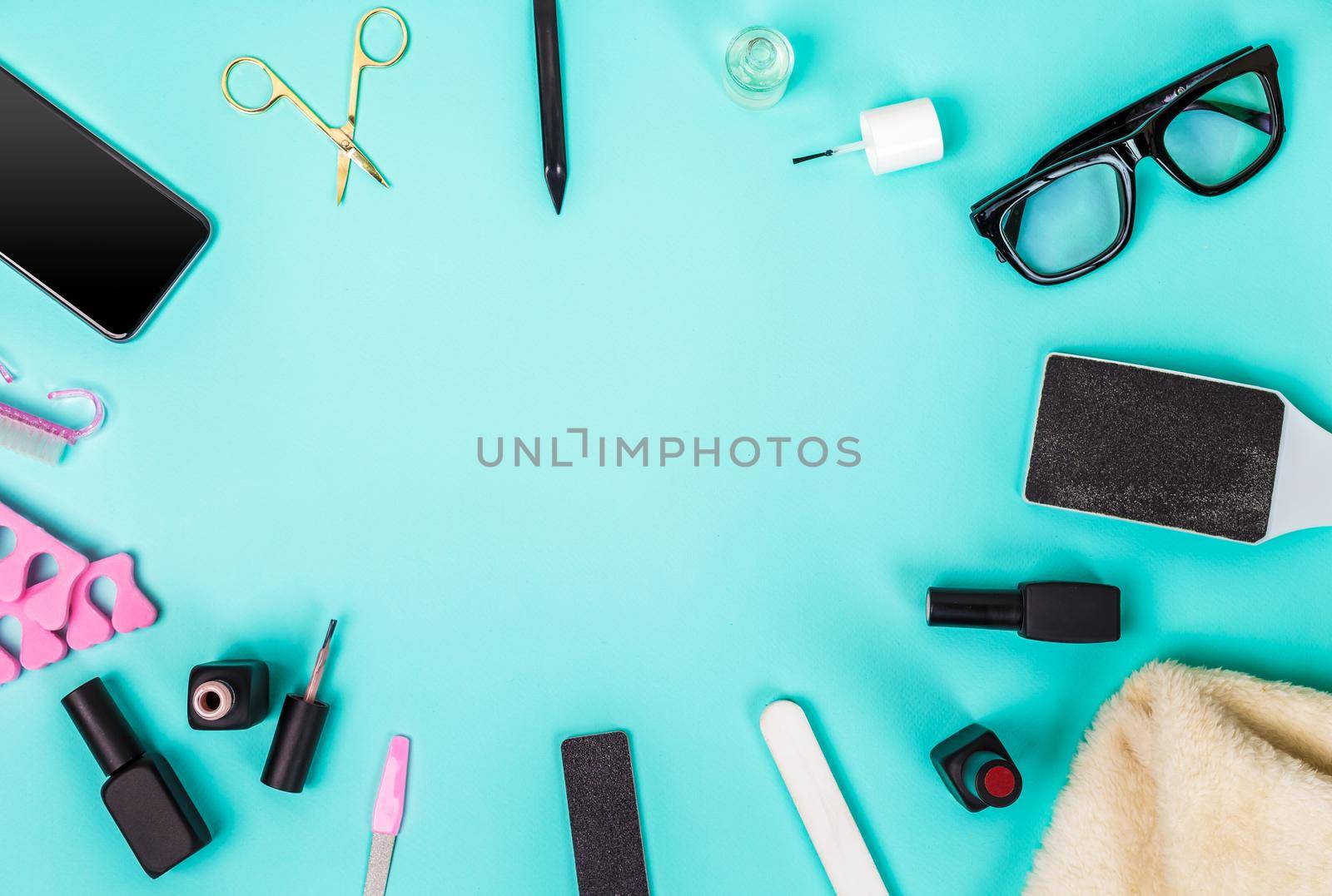 Top view of manicure and pedicure equipment on blue background. Still life. Copy space