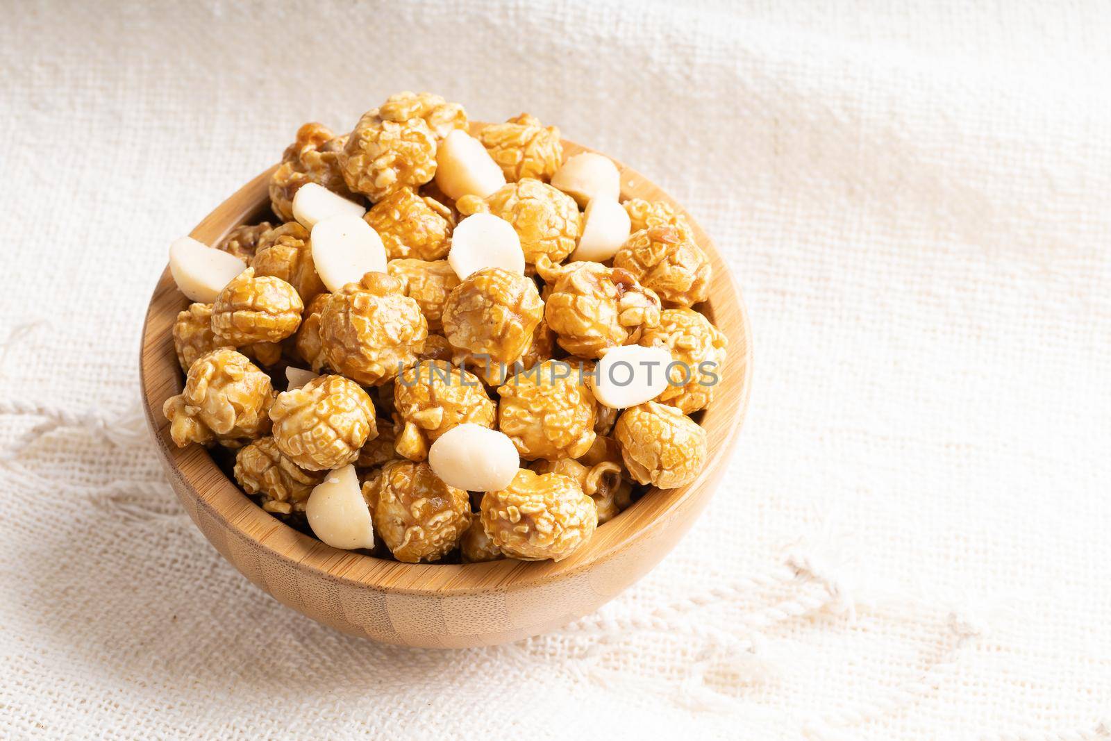 Caramel popcorn with macadamia nut in bamboo wooden bowl by smuay