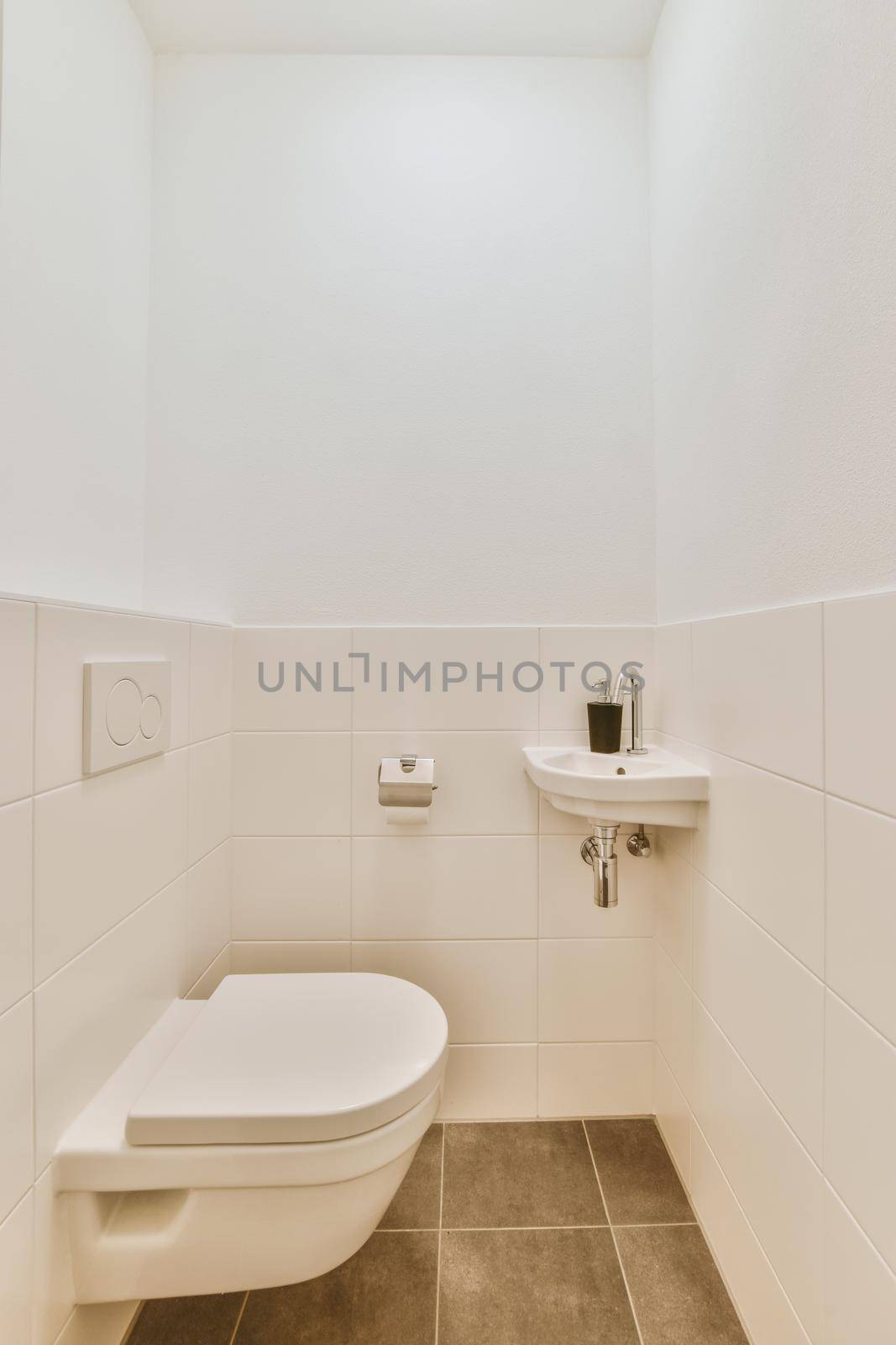 Stylish interior design of a bathroom with ceramic sink and toilet in a modern apartment