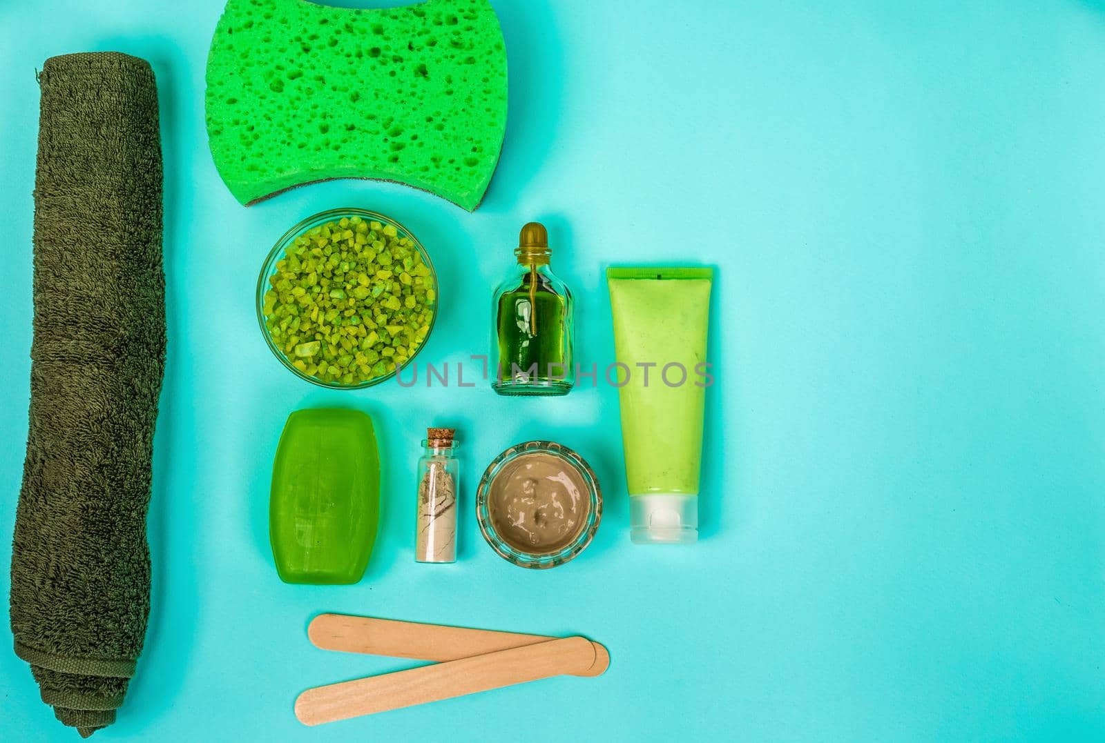 Spa set: soap, mask, oil, sea salt and towel. Top view. Still life Copy space
