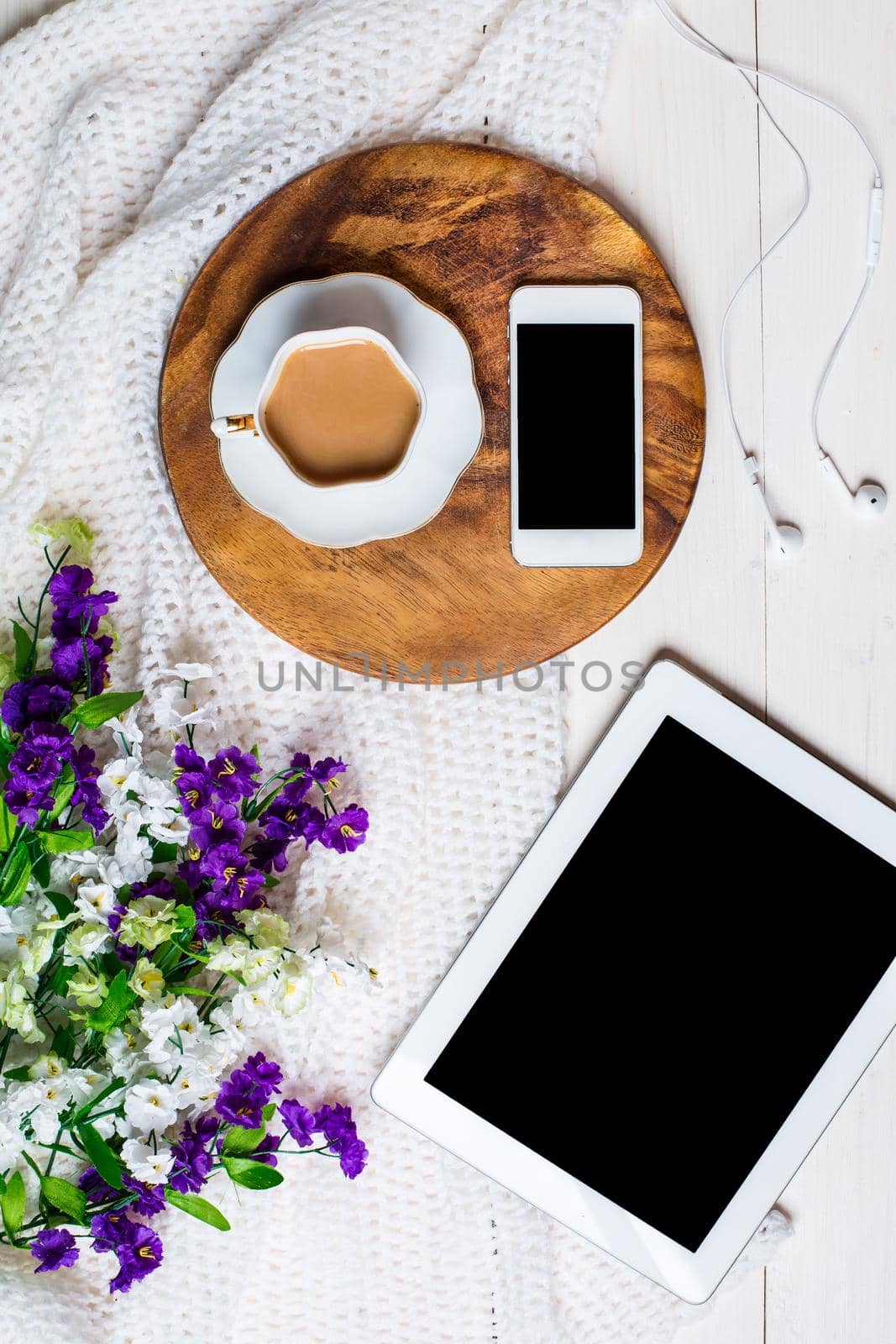 Flat lay, top view, mock up women's accessories on a white background. phone, tablet, a cup of coffee
