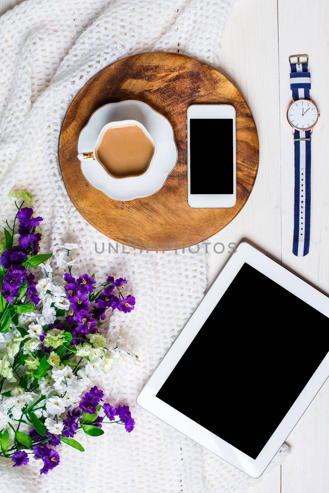 Flat lay, top view, mock up women's accessories on a white background. phone, tablet, a cup of coffee