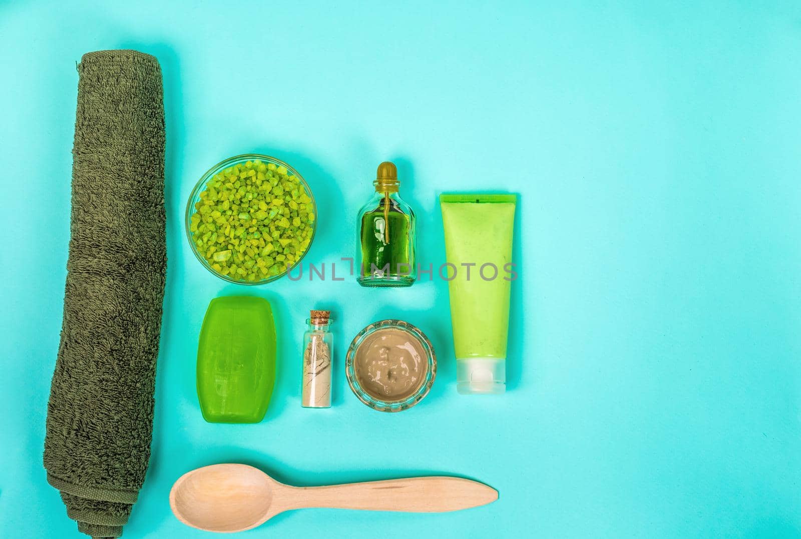 Spa set: soap, mask, oil, sea salt and towel. Top view. Still life Copy space