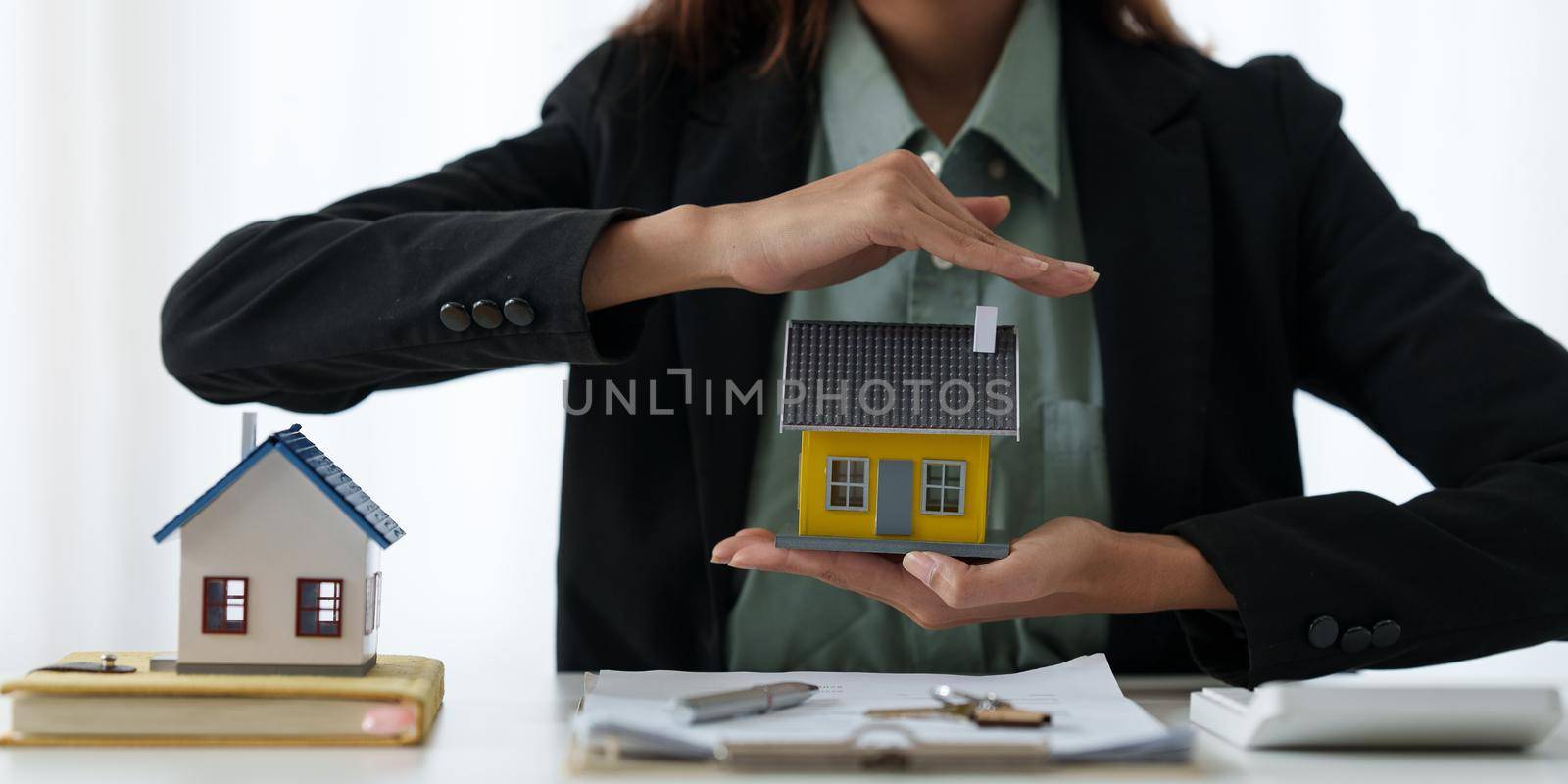 A woman holding and checking house model .Real Estate House Appraisal And Inspection and Insurance concept