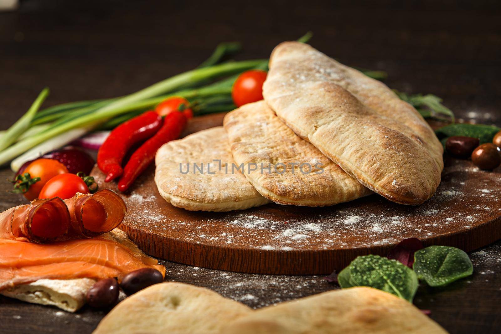 Doner kebab or pita on a wooden tray.