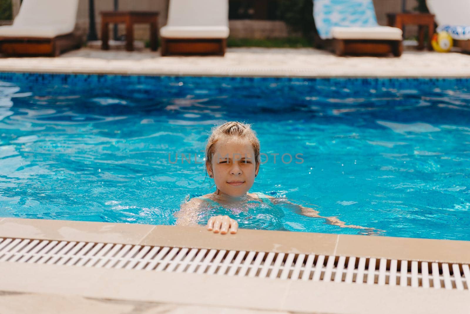 Happy child having fun on summer vacation. Kid playing with rubber duck and ball in the sea. Healthy lifestyle concept. Happy child playing in swimming pool. Summer vacations concept