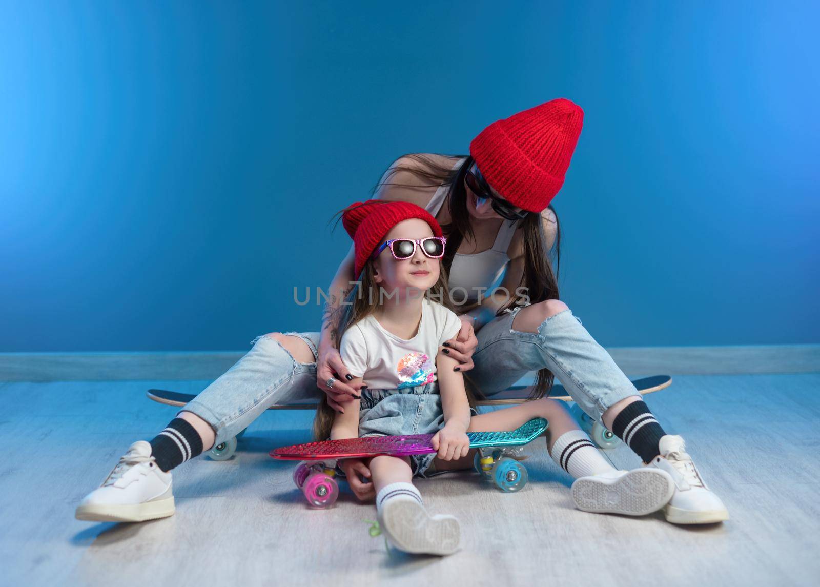 young mother with her daughter on a skateboard and a longboard