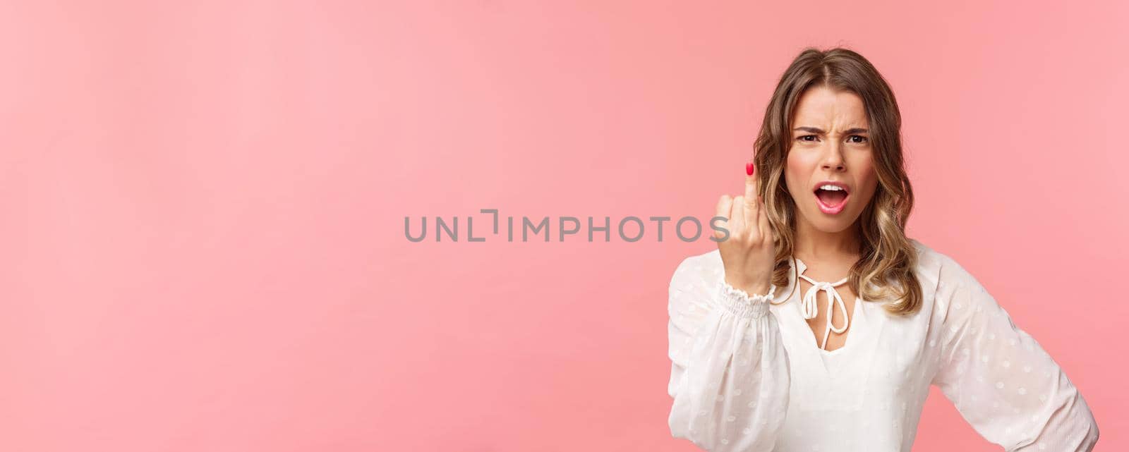 Close-up portrait of pissed-off bothered and fed up blond girlfriend arguing with boyfriend, showing him finger without ring as willing finally get married, standing upset pink background by Benzoix