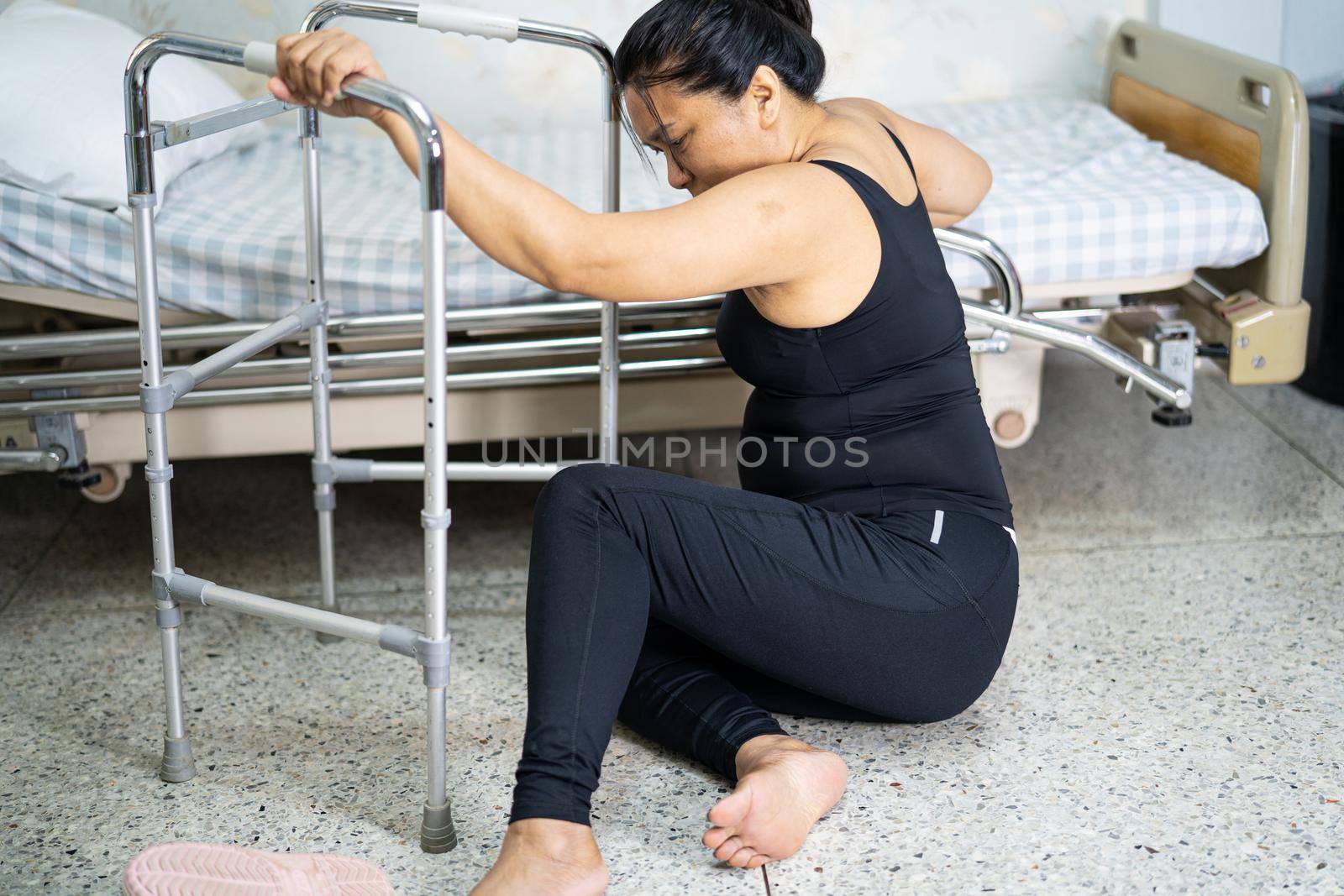 Asian middle-aged lady woman patient falling in living room because slippery surfaces by pamai