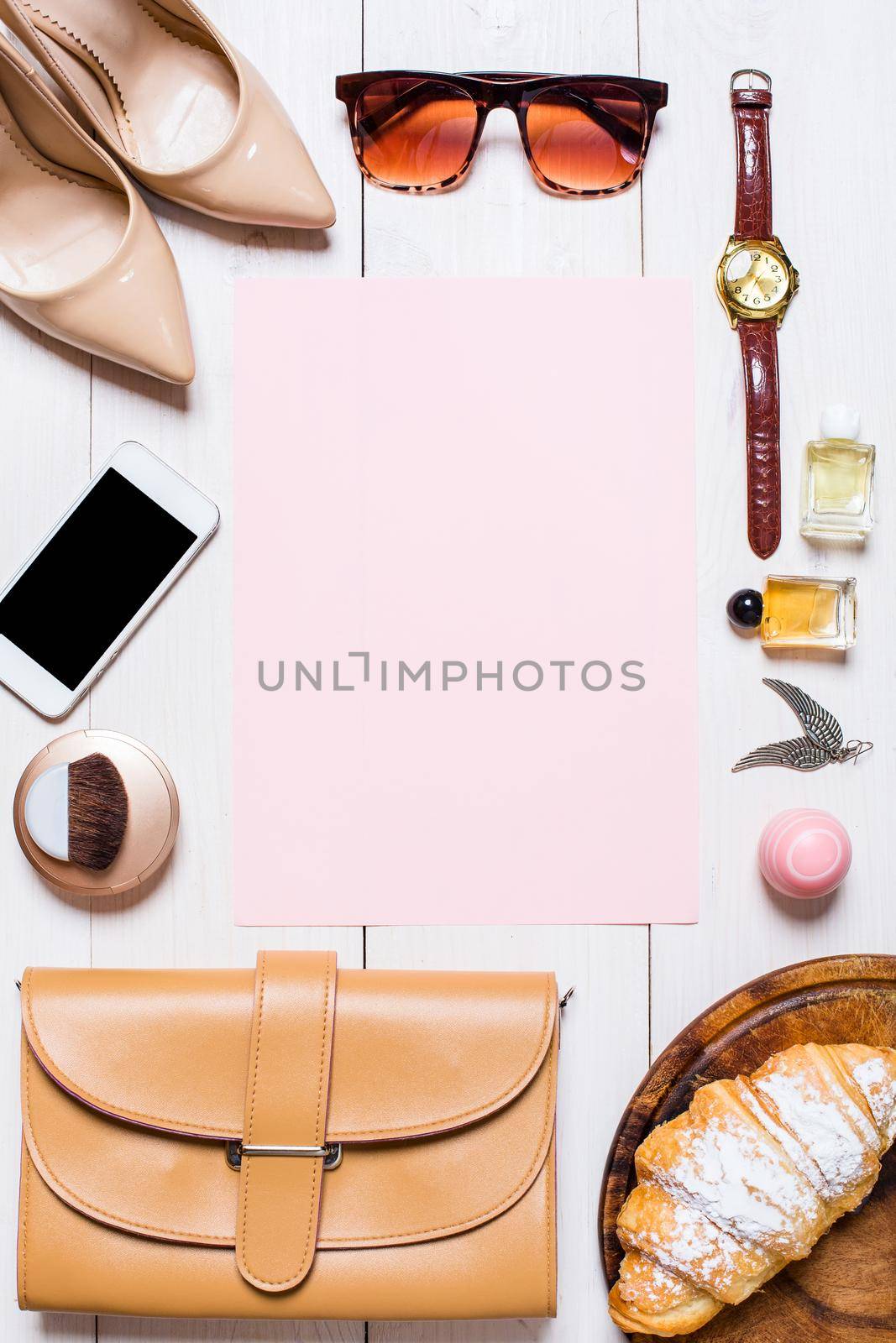 Flat lay, top view, mock up women's clothes and accessories on a white background. phone, shoes, perfume, sunglasses, croissant