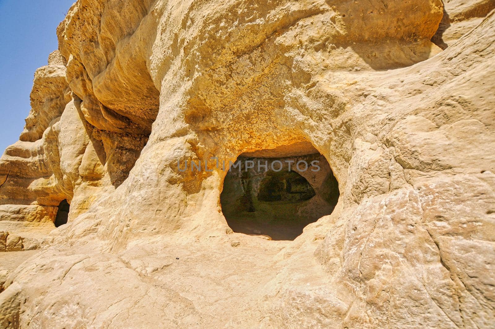 Matala beach with caves on the rocks that were used as a roman cemetery and at the decade of 70's