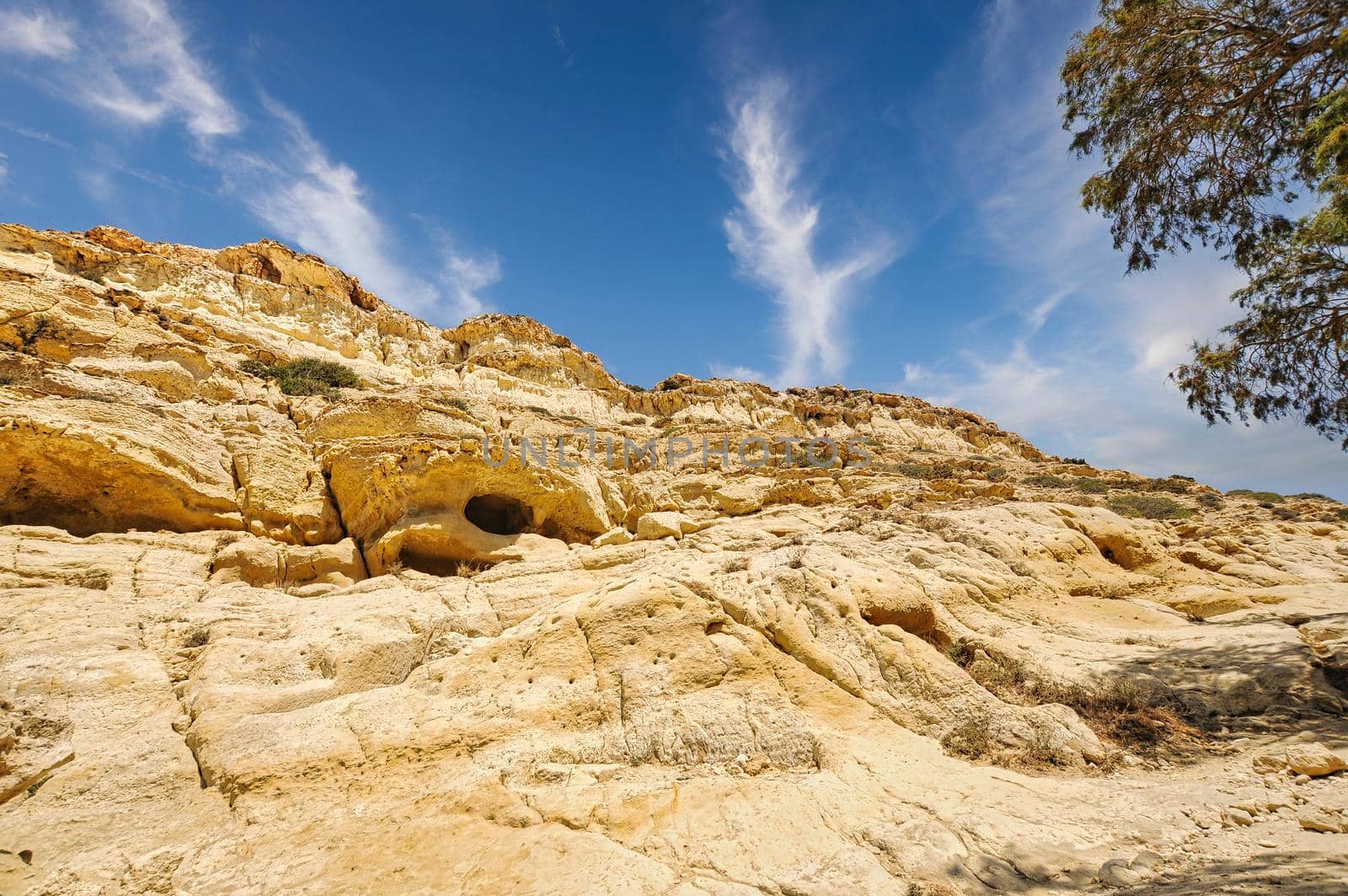 Matala beach with caves on the rocks that were used as a roman cemetery and at the decade of 70's