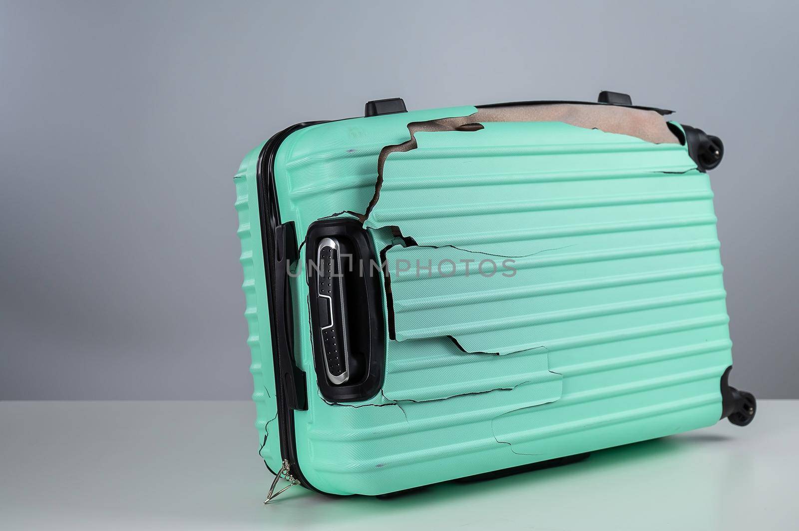 Mint damaged suitcase on a white background. by mrwed54