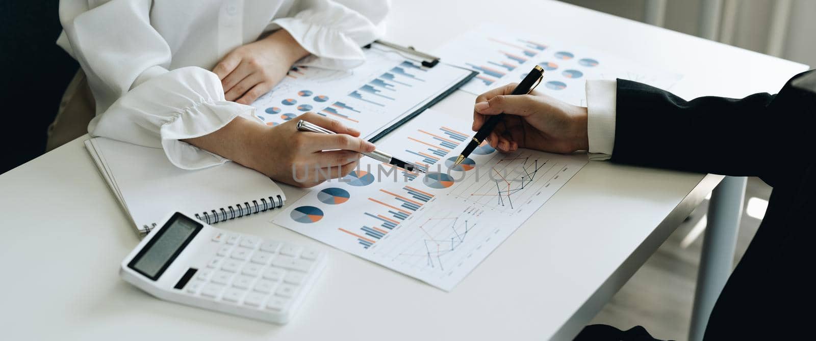 Close up business team hands at working with financial plan, meeting, discussion, brainstorming on the office desk,