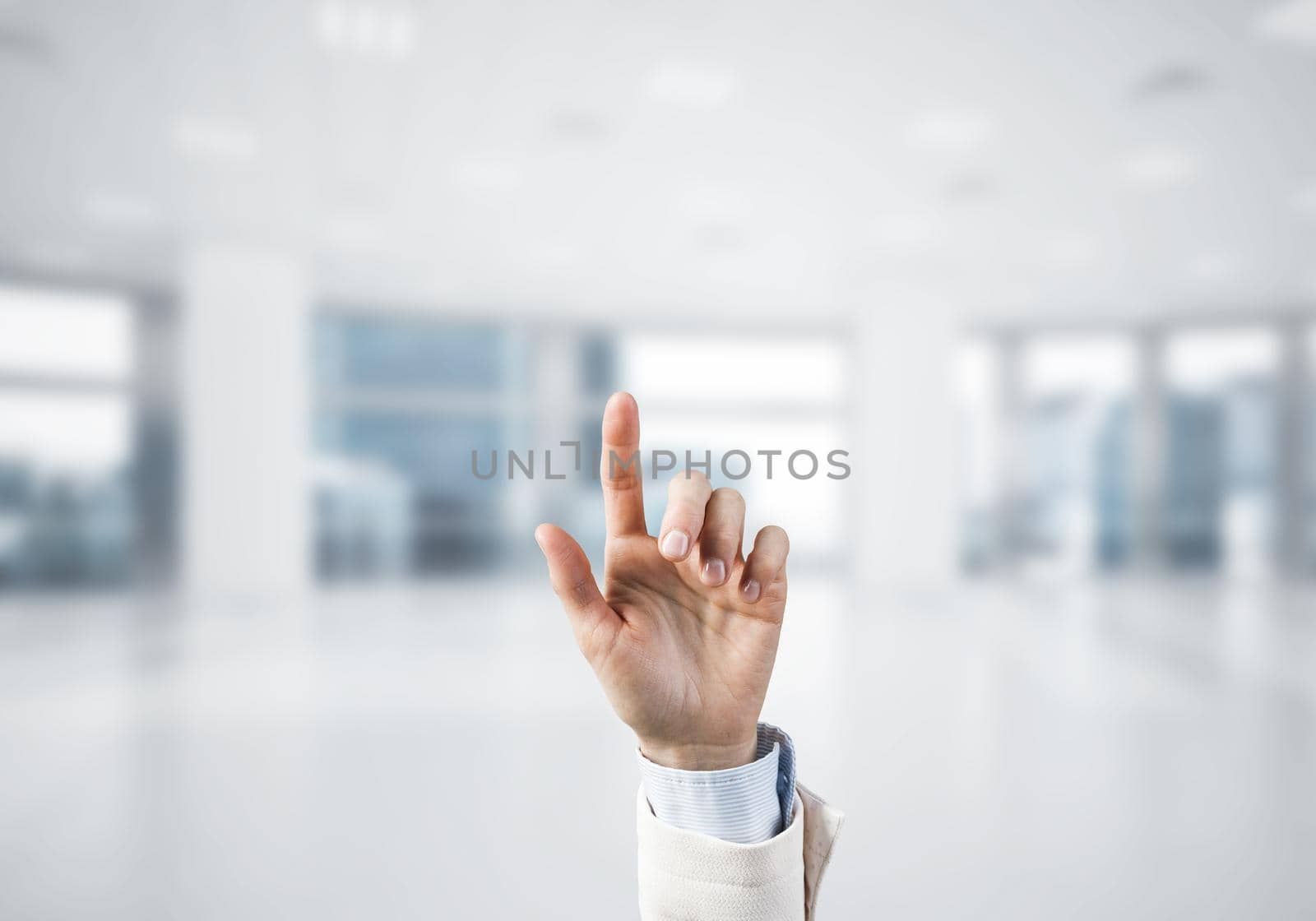 Choosing gesture of businessperson in elegant modern interior in sunshine light by adam121