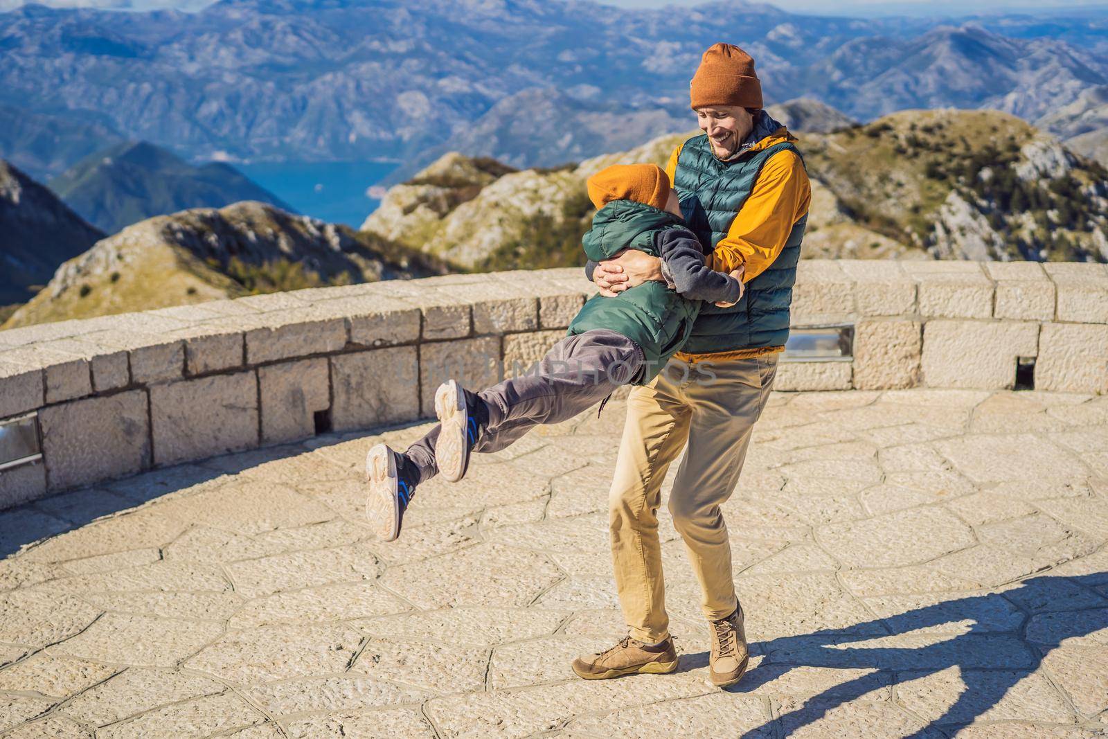 Dad and son travellers in mountain landscape at national park Lovcen, Montenegro. Travel to Montenegro with children concept.