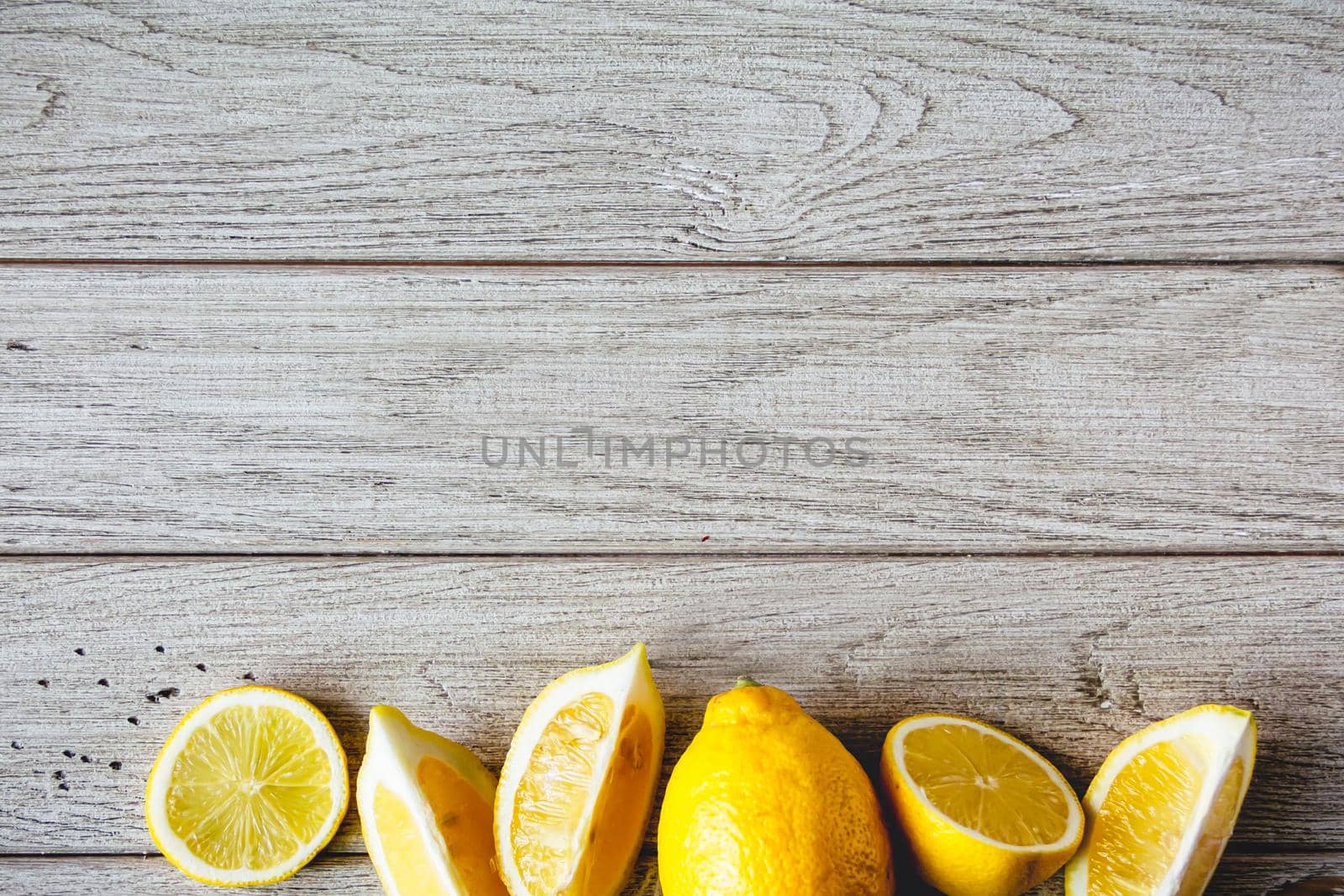 Fresh sliced lemon on wooden natural background with space for text. Healthy food concept.