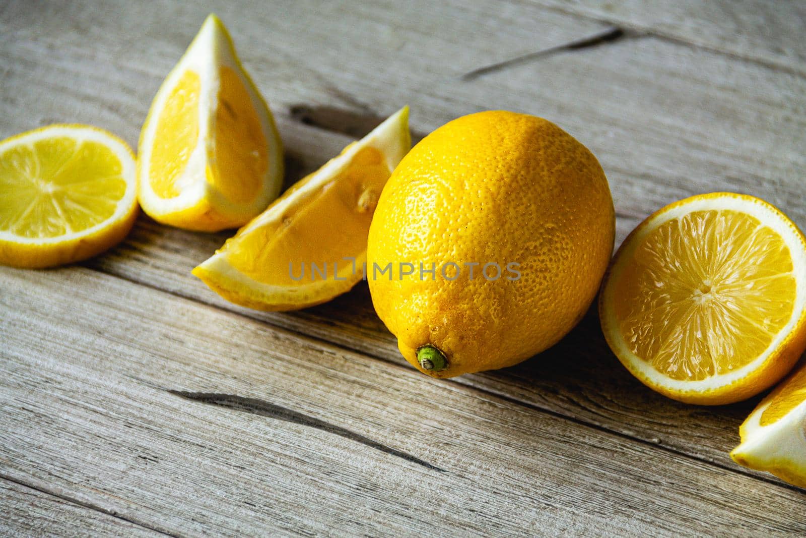 fresh sliced lemon on wooden natural background