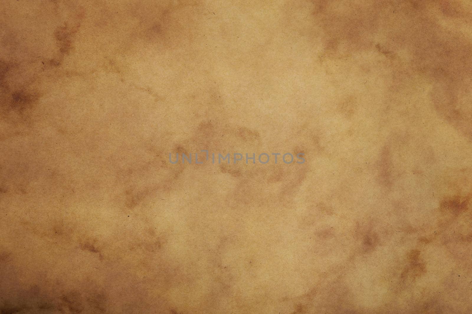 Old vintage grunge brown paper parchment background texture with dark stains