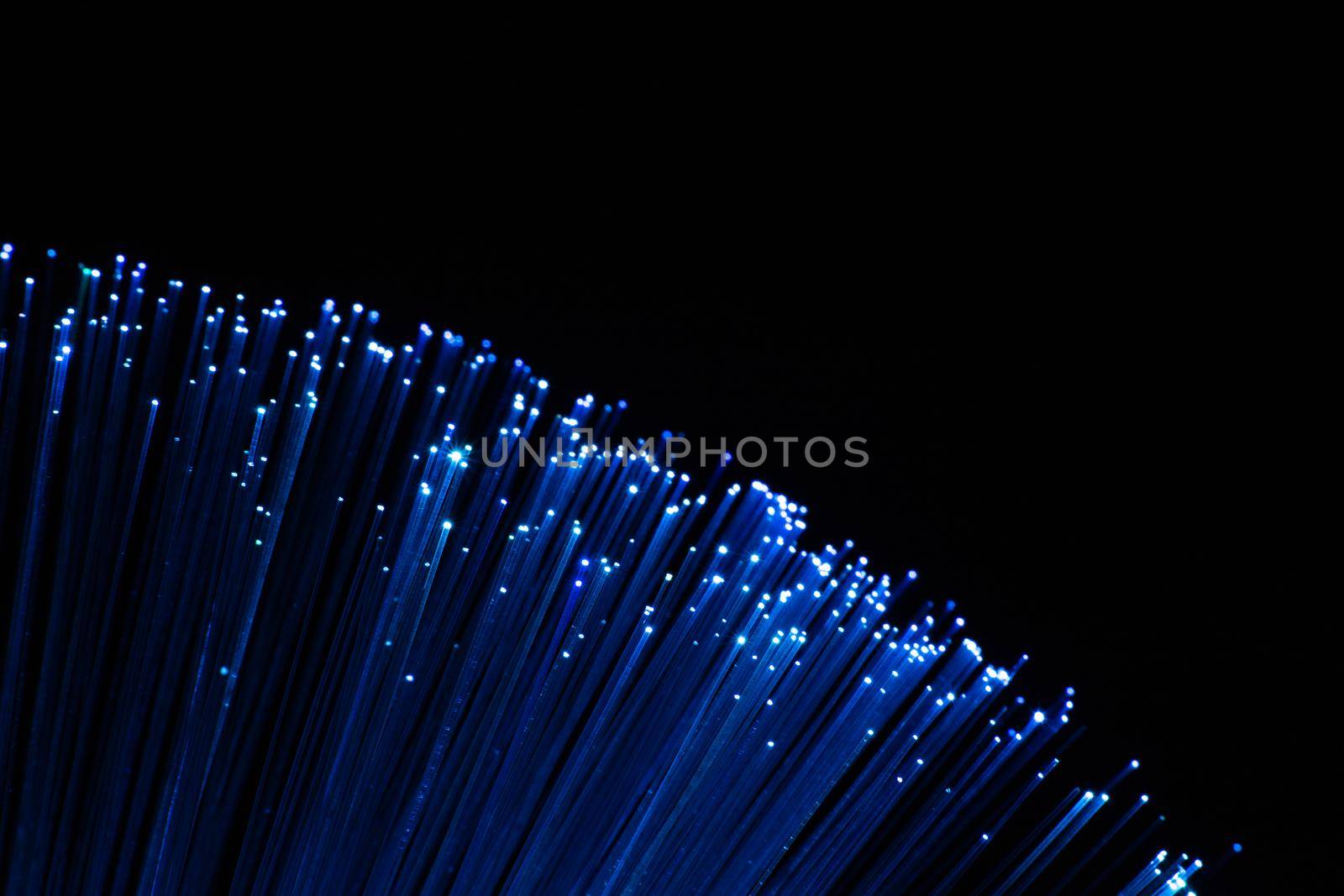 perfectly focused arc shaped blue fiber optic lights on black background