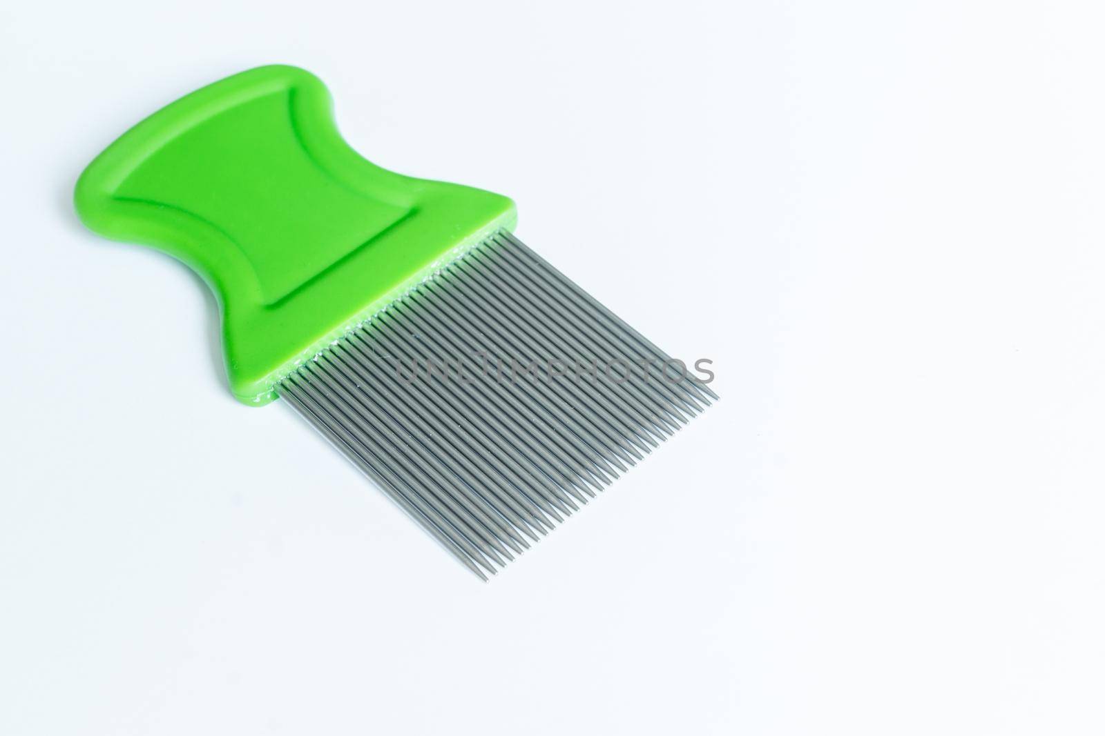 macro image of green nit comb on white background