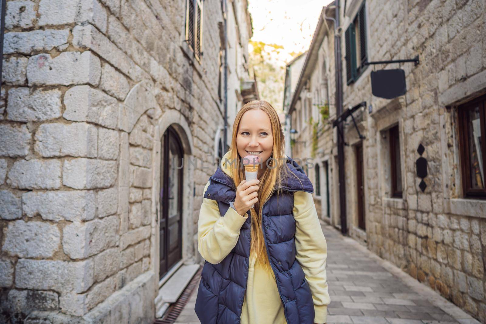 Woman tourist enjoying Colorful street in Old town of Kotor on a sunny day, Montenegro. Travel to Montenegro concept.