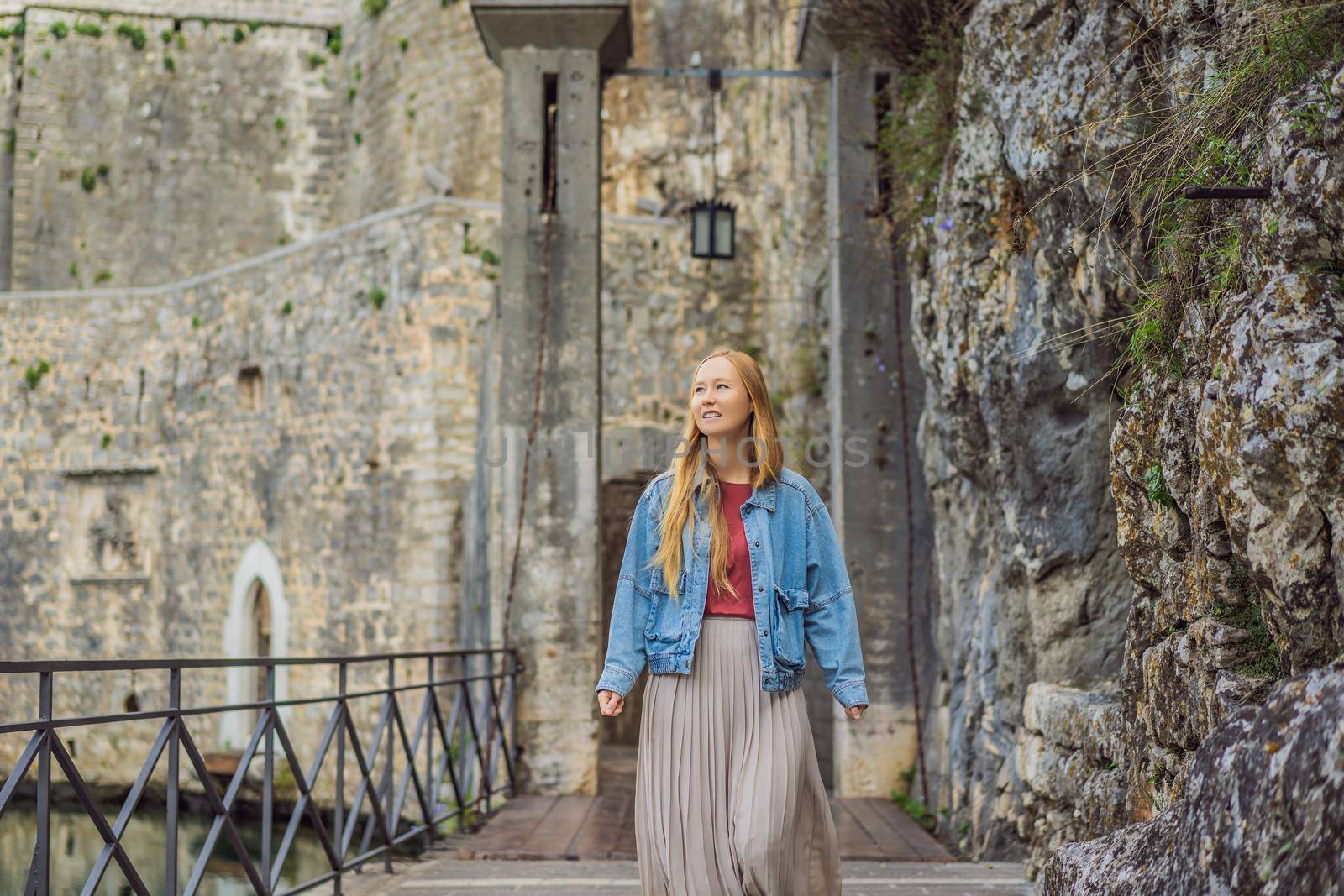 Woman tourist enjoying Colorful street in Old town of Kotor on a sunny day, Montenegro. Travel to Montenegro concept by galitskaya