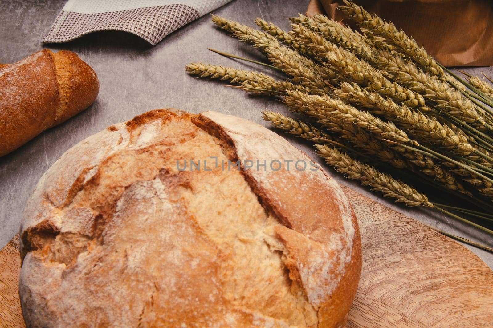 Artisan bread with wheat cereals on a stone table