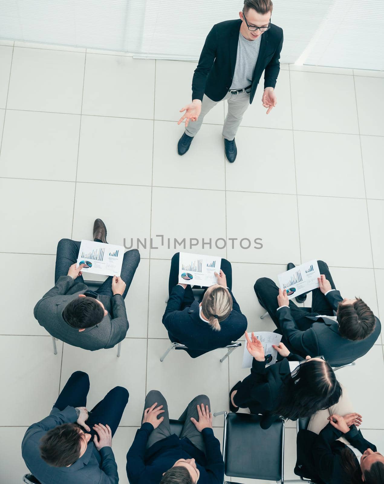 top view. working group applauding at a business meeting.