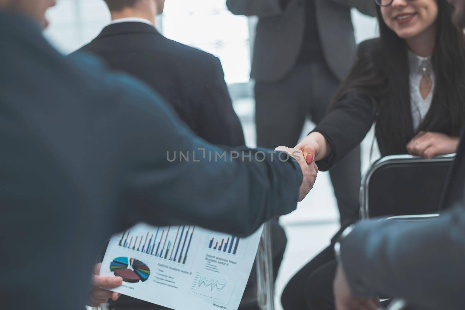 business colleagues shaking hands with each other during the workshop . business concept
