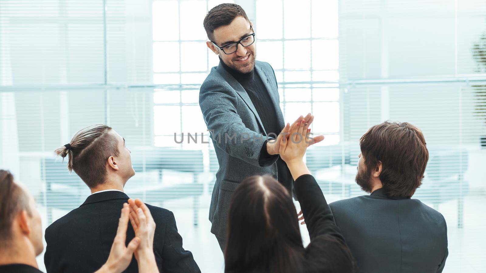 business colleagues giving each other a high five . the concept of success